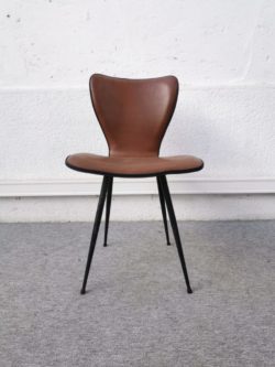 Une jolie chaise dans le goût d’arne jacobsen. En skaï brun et piétement en métal noir. Bon état. Hauteur de l’assise: 45cm. Longueur: 45 cm. Hauteur: 79 cm. Profondeur: 45 cm.